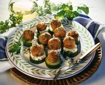 Pork balls with capers on cucumber slices