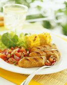 Grilled sausages, sweetcorn and lettuce