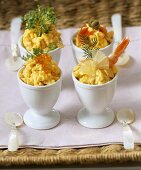 Scrambled egg with various toppings in egg cups