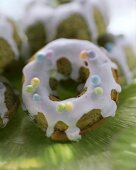 Pistachio cookies with icing and coloured sugar pearls