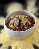 A bowl of red rice with mushrooms