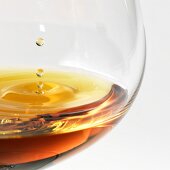 Cognac dripping into a brandy glass