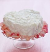 Heart-shaped coconut cake with rose petals