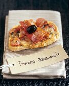 Cheese and tomatoes on toast with bacon and olive