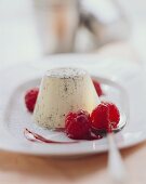 Panna cotta (turned-out cream dessert with raspberry sauce)