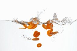 Carrot slices falling into water