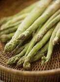 Green asparagus on a wicker tray