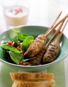 Middle Eastern mince kebabs with spinach salad