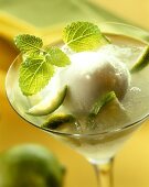 Lime & vodka drink with a scoop of lime sorbet in glass
