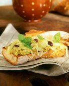 Baguette with olive cream, olives and onions
