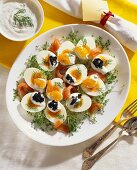 Boiled eggs garnished with salmon and caviare