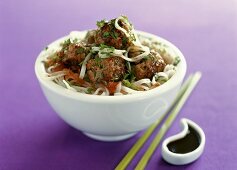 Meatballs with coriander on rice noodles