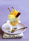 Poached pear with cream and cinnamon in glass