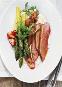 Asparagus salad with roast duck breast, strawberries and rocket