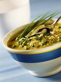 Barley soup with peas, garlic and chives