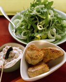 Three pork fillets with pepper dip and rocket and celery salad