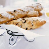 Olive breads and rolls on wire basket with napkin