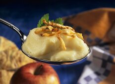 A spoonful of mashed potato with fried celery strips