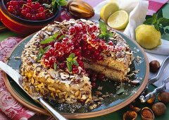 Redcurrant and semolina cake with chopped nuts, a piece cut