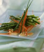 Green asparagus with pepper strips on a plate