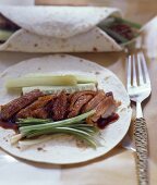 Peking duck with spring onions on pancakes