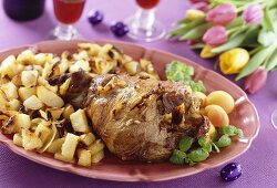 Leg of lam with roast potatoes and apricots