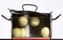 Dumplings boiling in a pan of water