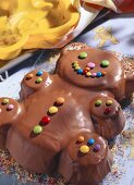 Chocolate cake in shape of bear with coloured chocolate beans