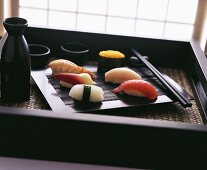 Nigiri sushi on black tray