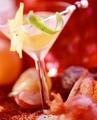 Champagne sangria in glass, surrounded by candied fruit