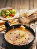 French cheese fondue with peppers; white wine; bread; salad