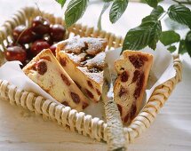 Pieces of cherry quark cake on paper in basket