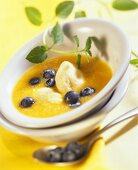 Cold peach soup with semolina dumplings and blueberries