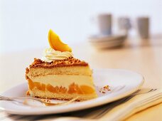 Piece of apricot and hazelnut gateau with cream