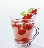 Punch with various berries in glass