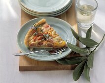 Piece of pepper quiche on plate on chopping board