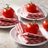 Italian table decoration with checked napkins and tomatoes