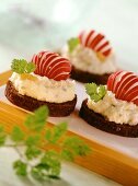 Pumpernickel with potato and herb spread and radishes