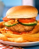 Hamburger with ketchup and chips