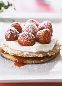 Strawberry and almond tartlet with cream and icing sugar