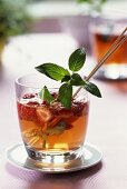 Strawberry punch with sprig of mint in glass