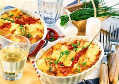 Baked cheese with tomatoes, chili peppers and chives