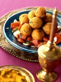 Arab potato and bulgur balls on tomato salad