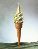 White and green soft ice cream in cone