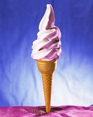 Soft raspberry ice cream in cone
