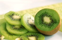 Kiwi fruit slices and half a kiwi fruit