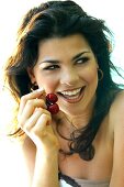 Young woman eating cherries