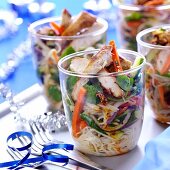 Pasta salad with vegetables and chicken in glasses
