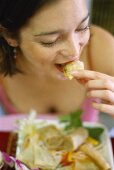 Woman eating spring roll