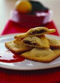 Ravioli with chocolate filling and strawberry sauce